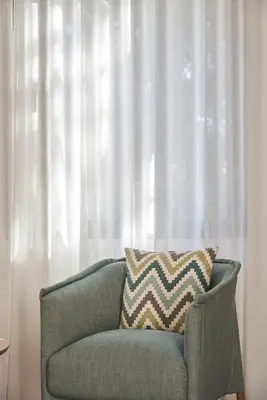a blue couch sitting in front of a window at Funchal Charming Villa in Funchal