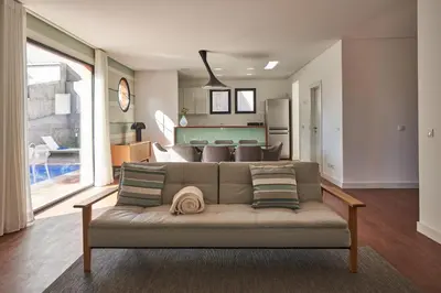 a living room with a couch and a dining room at Funchal Charming Villa in Funchal