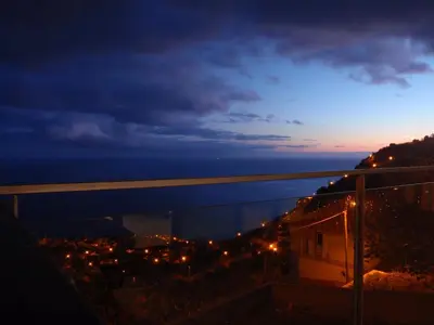 a view of a city at night at Villa Girasol in Arco da Calheta