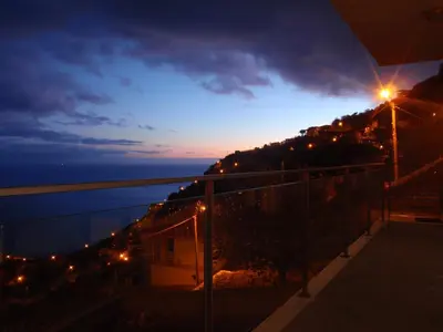 a view of the ocean at night from a balcony at Villa Girasol in Arco da Calheta
