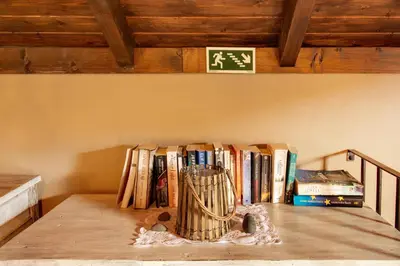 a group of books sitting on a table with rocks at The Perfect Cottage in São Vicente