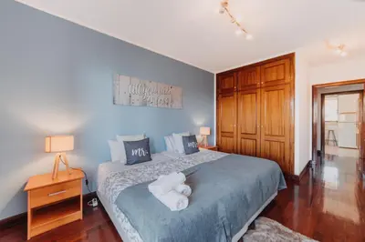 a bedroom with a bed with two white towels on it at Funchal Lounge Apartment by Amazing Madeira in Funchal