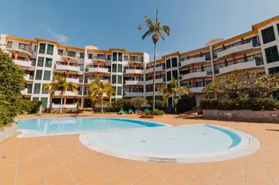 a swimming pool in front of a large apartment building at Funchal Lounge Apartment by Amazing Madeira in Funchal