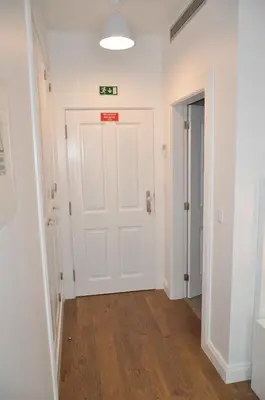 a hallway with a white door with a sign on it at Edificio Charles 103 in Funchal