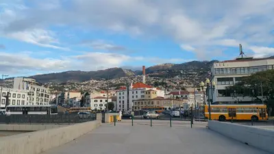 a city with a yellow bus parked on a street at Edificio Charles 206 in Funchal