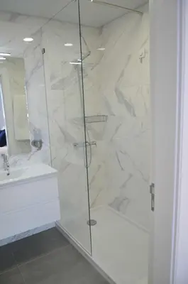 a white bathroom with a shower and a sink at Edificio Charles 206 in Funchal