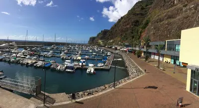 a marina filled with lots of boats in the water at Marina Rooms in Calheta