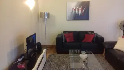 a living room with a couch and a table at Funchal Bay View Holiday Rental in Funchal