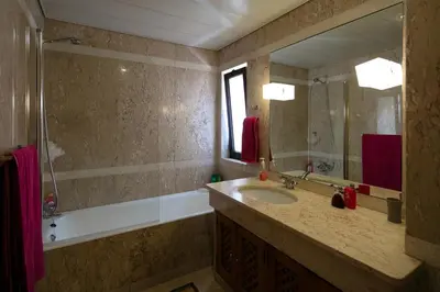 a bathroom with a sink and a mirror at Funchal Bay View Holiday Rental in Funchal