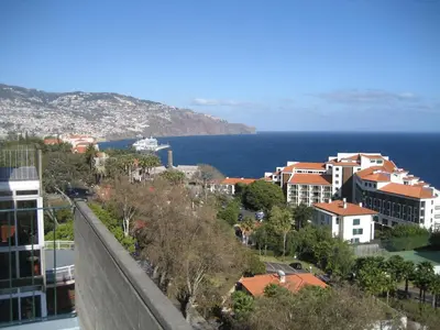 a view of a city with the ocean and buildings at Yourpenthouseinmadeira in Funchal