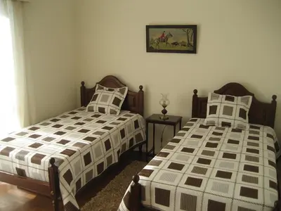 two beds sitting next to each other in a bedroom at Yourpenthouseinmadeira in Funchal