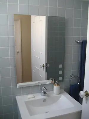 a bathroom with a white sink and a mirror at Yourpenthouseinmadeira in Funchal