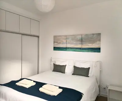 a bedroom with a bed with two towels on it at Porto Santo - Pedras Pretas Beach House in Porto Santo