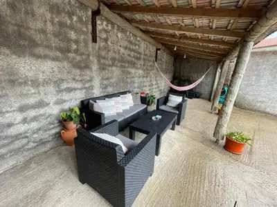 a patio with two tables and chairs and potted plants at Casa da Grota in Porto Moniz