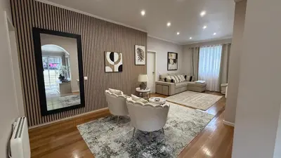 a living room with two chairs and a mirror at Casa da Grota in Porto Moniz