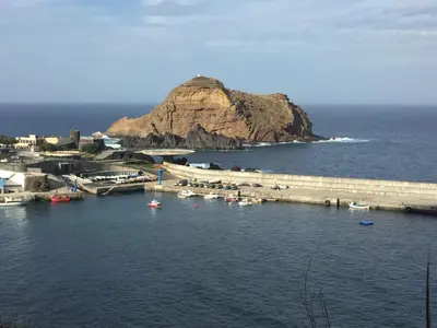 a group of boats in a body of water at Casa da Grota in Porto Moniz