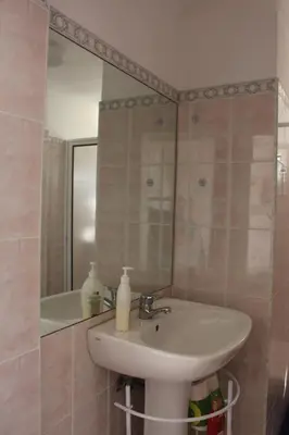 a bathroom with a sink and a mirror at Casa dos Caseiros in Santa Cruz