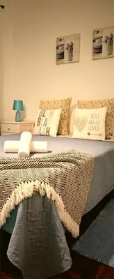 a bedroom with a bed with a blanket and pillows at City Apartment in Funchal