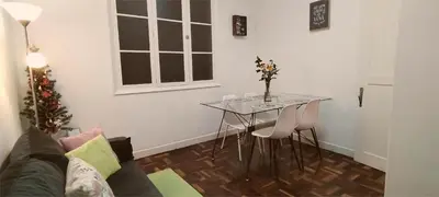 a living room with a table and a couch at City Apartment in Funchal