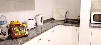 a kitchen counter with a sink and a microwave at City Apartment in Funchal