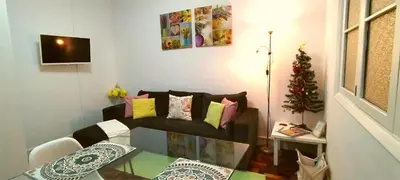 a living room with a couch with colorful pillows at City Apartment in Funchal