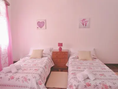 a bedroom with two beds and a dresser at City Apartment in Funchal
