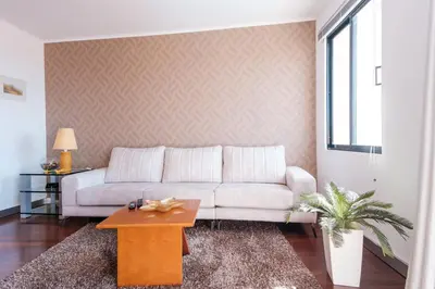 a living room with a white couch and a table at Varandas Funchal-Near center in Funchal