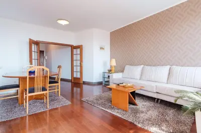 a living room with a white couch and a table at Varandas Funchal-Near center in Funchal