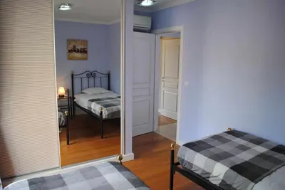 a bedroom with a bed and a mirror at Plaza Bay Luxury Apartment with Swimming Pool in Estreito da Calheta