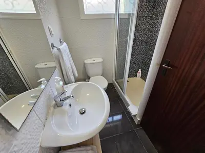 a bathroom with a sink and a toilet at Inmaculado Apartment in Funchal