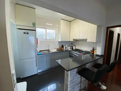 a kitchen with a white refrigerator and a counter at Inmaculado Apartment in Funchal