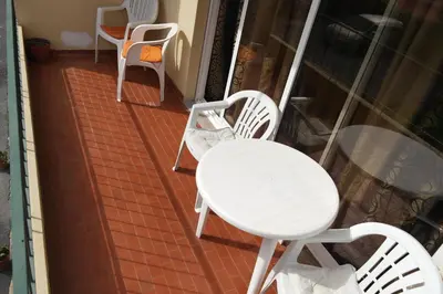 a white table and chairs on a balcony at Inmaculado Apartment in Funchal