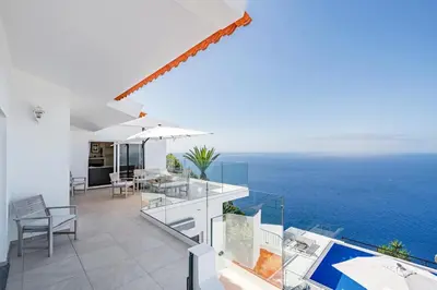 a balcony with a view of the ocean at OurMadeira - Villa Aquarela in Caniço