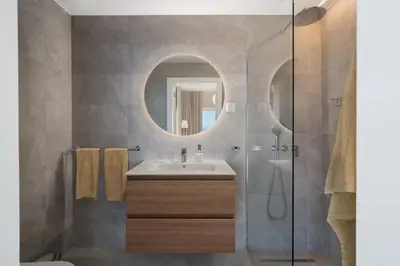 a bathroom with a sink and a mirror at OurMadeira - Villa Aquarela in Caniço