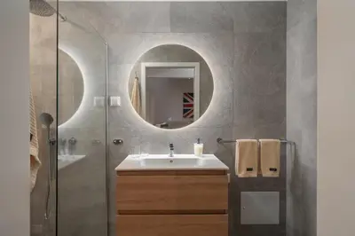a bathroom with a sink and a mirror at OurMadeira - Villa Aquarela in Caniço