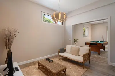a living room with a couch and a pool table at OurMadeira - Villa Aquarela in Caniço