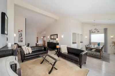 a living room with two leather couches and a table at OurMadeira - Villa Aquarela in Caniço