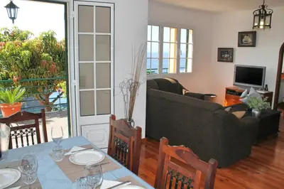 a living room with a couch and a table at OurMadeira - Casa Jardim Mar in Ponta do Sol