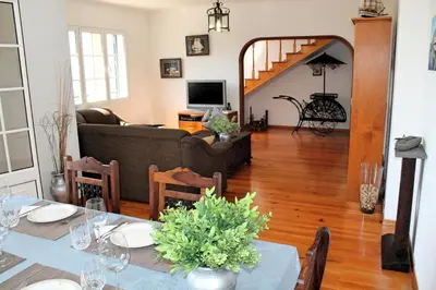 a living room with a table and a couch at OurMadeira - Casa Jardim Mar in Ponta do Sol