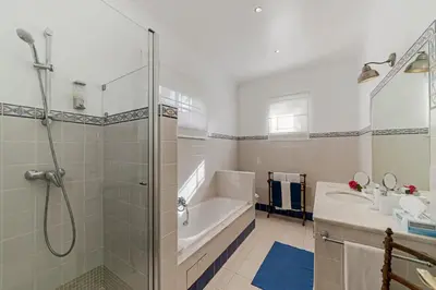 a bathroom with a shower and a tub and a sink at OurMadeira - Quinta D'Alegria in Funchal