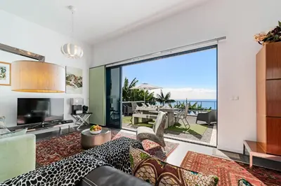 a living room with a view of the ocean at OurMadeira - Grayci's House in Arco da Calheta