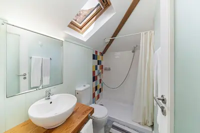 a bathroom with a sink and a shower and a toilet at OurMadeira - Villa do Mar II in Arco da Calheta