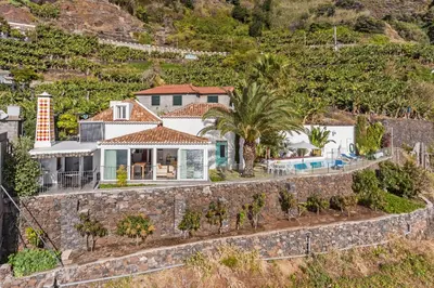 an aerial view of a house with a stone wall at OurMadeira - Villa do Mar II in Arco da Calheta