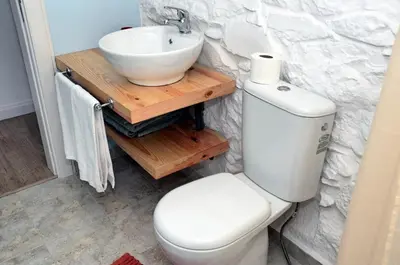 a bathroom with a white toilet and a sink at OurMadeira - Villa do Mar II in Arco da Calheta