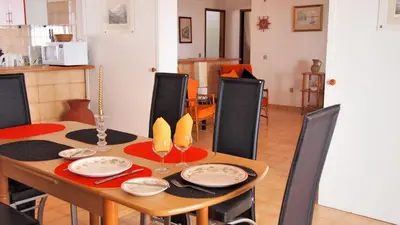 a dining room with a table and chairs and a kitchen at OurMadeira - Villa Mary in Porto Santo