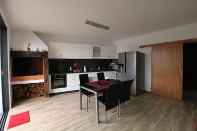 a kitchen with a table and chairs in a room at Refúgio da Xamusca in São Vicente