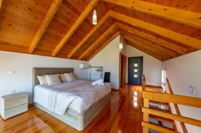 a bedroom with a bed and wooden ceilings at Refúgio da Xamusca in São Vicente