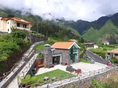 a house on the side of a mountain at Refúgio da Xamusca in São Vicente