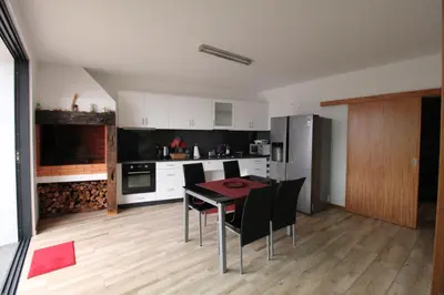 a kitchen with a table and chairs in a room at Refúgio da Xamusca in São Vicente
