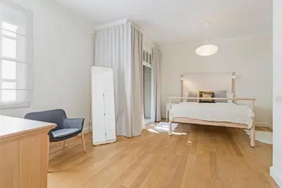a white bedroom with a bed and a chair at Vila Eucalipto by An Island Apart in Funchal